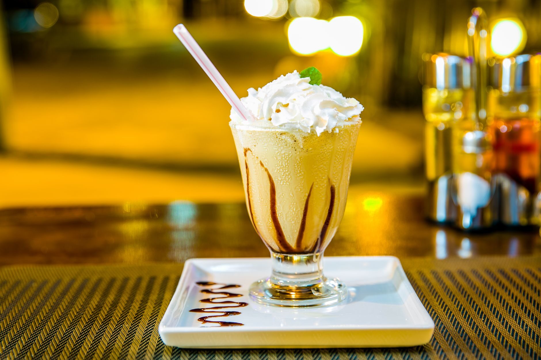 A classic tall milkshake with whipped cream and caramel drizzle.